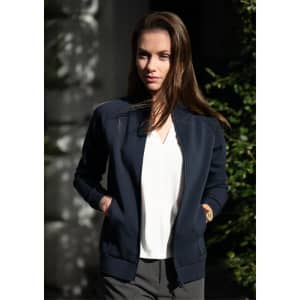 A navy jacket with a zip front and pockets, worn by a model outdoors. The jacket has a simple design and a logo.