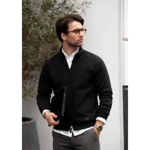A black Eaton Men Jacket with a zip front, worn by a man in glasses, against a neutral backdrop.
