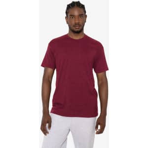 A maroon short sleeve cotton-polyester crew tee displayed on a model, featuring a simple design and a logo.