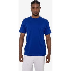 A model wearing a blue short sleeve cotton poly crew tee alongside light grey trousers. The shirt features a logo.