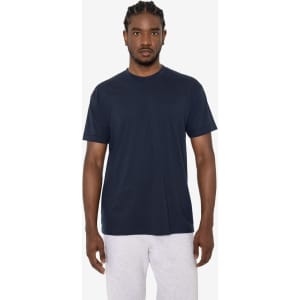 A navy short sleeve cotton-poly crew tee on a model, featuring a simple design and a logo.