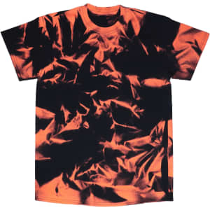 A Nebula Tie Dye T-Shirt featuring bold orange and black swirling patterns, with a logo on it.