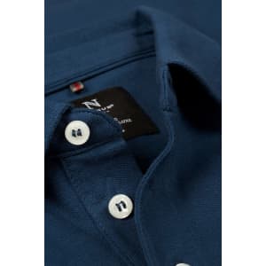 A navy polo shirt featuring a collared neck and button closure, showcasing a textured fabric.