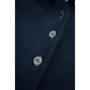 A navy women's polo shirt featuring a button placket and a logo. The fabric has a textured finish.