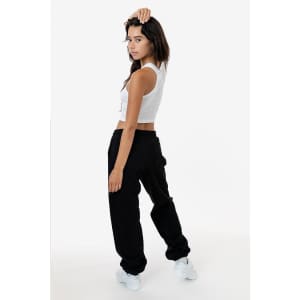A model wearing black heavy fleece sweatpants paired with a white crop top, showcasing a side view.