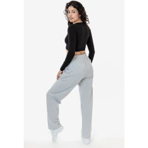 Straight leg heavy fleece pant in grey, featured on a model wearing a black cropped top. The product includes a logo.