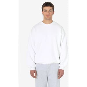 A heavy fleece pullover in white, featuring long sleeves and a relaxed fit. The model is wearing grey pants.