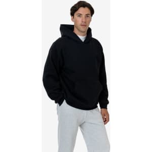 A heavy fleece hood pullover in navy blue, worn by a model, featuring a front pocket and a hood.