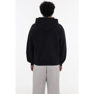 A black heavy fleece zip-up hoodie displayed on a model from the back, paired with grey sweatpants.