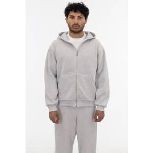 A grey heavy fleece zip-up hoodie with a front zipper and hood, modelled by a person.