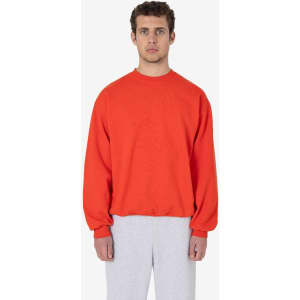 A heavy fleece pullover in vibrant red, featuring long sleeves and a relaxed fit, paired with grey pants.