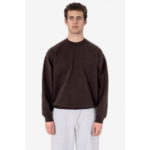 A brown heavy fleece pullover with long sleeves, worn by a model, paired with light grey pants.