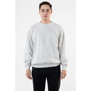 A man wearing a light grey garment dye heavy fleece pullover, standing against a plain background.