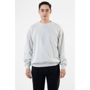 A man wearing a light grey garment dye heavy fleece pullover, standing against a plain background.