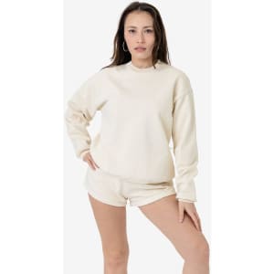 A cream-coloured heavy fleece pullover worn by a model, featuring a relaxed fit and long sleeves.