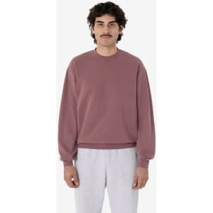 A mauve garment dye heavy fleece pullover with long sleeves, displayed on a model wearing grey pants.