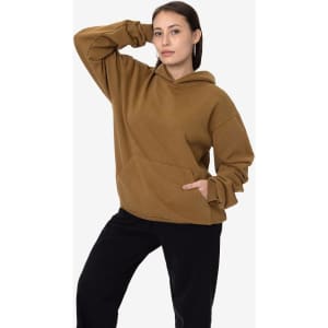A brown heavy fleece hooded pullover with a front pocket, worn by a model posing in casual attire.