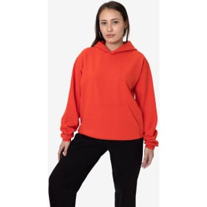 A heavy fleece hooded pullover in vibrant red, featuring long sleeves and a front pocket, modelled by a woman.