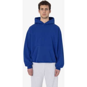 A blue heavy fleece hooded pullover is worn by a model, featuring a front pocket and a relaxed fit.