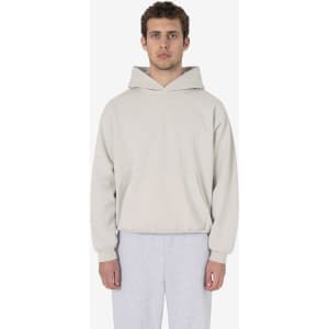 A hooded pullover in a light beige colour, with a relaxed fit and front pocket, featuring a logo.
