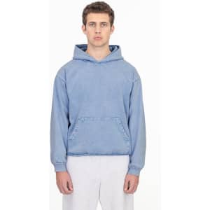 A blue mineral wash hooded pullover with a front pocket and a logo, worn by a model.