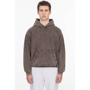 A heavy fleece hooded pullover in a mineral wash brown colour, featuring a front pocket and a loose fit.