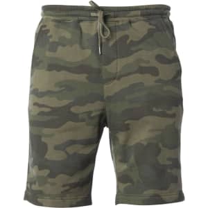 Camo-patterned midweight sweatshorts in shades of green. Features an elastic waistband with a drawstring and a logo.