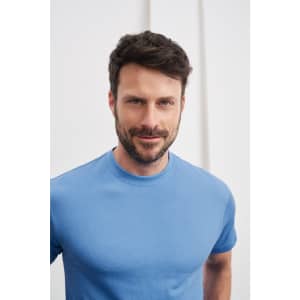 A blue t-shirt modelled by a man with short hair and a beard, featuring a logo on the shirt.