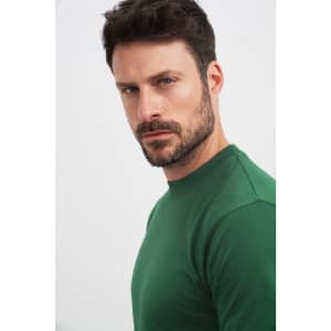 A green Round-T Heavy t-shirt displayed on a model, showcasing a fitted style and crew neck design.