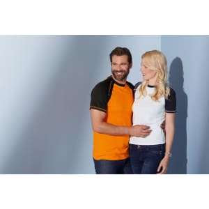 A man in an orange raglan T-shirt and a woman in a white raglan T-shirt pose together against a blue background.