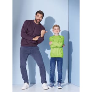 A man in a dark purple jumper and a boy in a bright green jumper pose together against a light blue background.