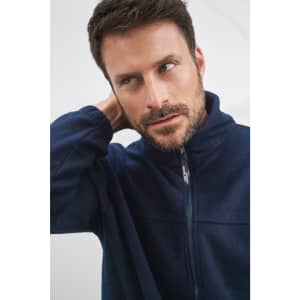 A man wearing a navy blue full-zip polar fleece jacket, featuring a collar and a branding logo.