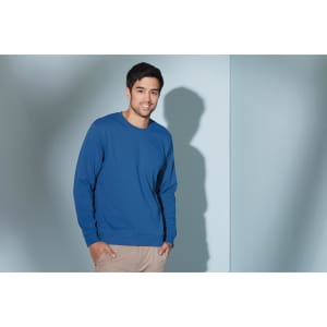 A blue sweatshirt featured on a male model against a light background, with a logo visible on the garment.