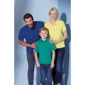 A family poses in three polo shirts: a blue shirt for the man, a green shirt for the boy, and a yellow shirt for the woman.
