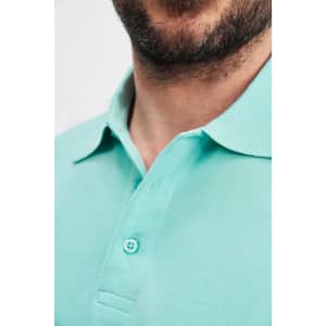 A close-up of a man's neck and collar wearing a mint green polo shirt with a button detail and logo.