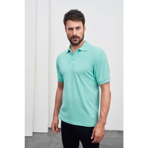 A mint green polo shirt featuring a collar and short sleeves, modelled by a man against a neutral background.