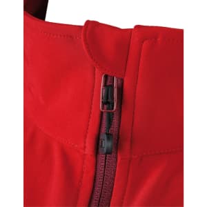 A close-up of a red ladies softshell jacket featuring a zip and collar design. The jacket has a logo on it.