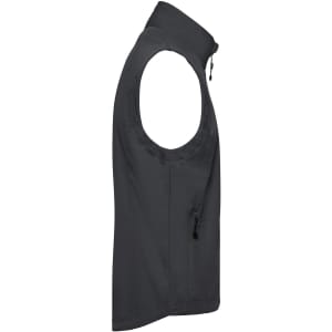 A men's softshell vest in dark grey, featuring a zip pocket and a high collar. It has a branded logo.