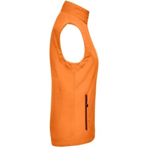 An orange ladies softshell vest featuring a zip pocket and a logo. It has no sleeves and a high collar.