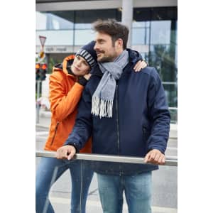 A navy soft shell jacket with a grey scarf is worn by a man, while a woman in an orange jacket leans against him.