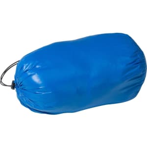 A blue down vest packed in a drawstring pouch, featuring a smooth, shiny exterior. It has a branding logo.