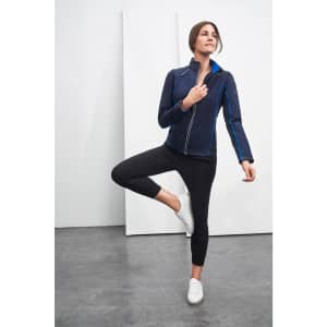 A navy zip-off softshell jacket with blue accents, worn by a woman in a stylish pose.