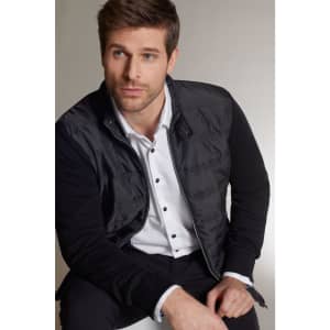 A men's hybrid sweat jacket, featuring a black body with a smooth finish and contrasting fabric on the sleeves.