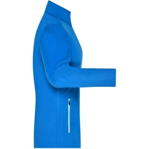 A blue ladies sports softshell jacket with a zippered pocket on the side and a high collar.