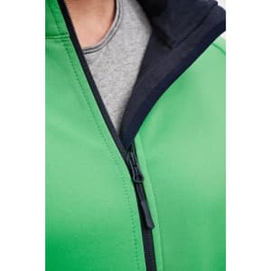 A green softshell jacket featuring a black hood and zipper detailing, with a grey shirt visible underneath.