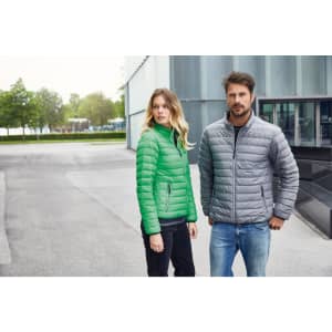 A green ladies down jacket and a grey men's jacket are displayed on two models outdoors. Both jackets have zipped pockets.