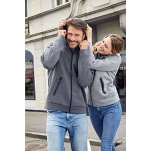 A grey ladies hooded jacket displayed on a woman, featuring a zip, pockets, and a logo.