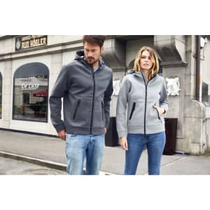 A grey and light grey hooded jacket with zip pockets, worn by a man and woman, both casually dressed.