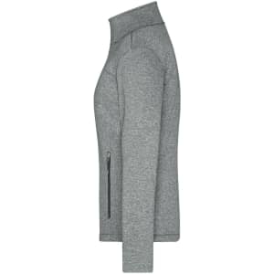 A softshell jacket in grey with a zippered pocket and a high collar, featuring a logo.