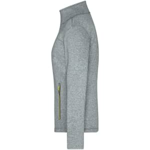 A grey ladies softshell jacket featuring a zip pocket and a high collar, with a logo on the design.